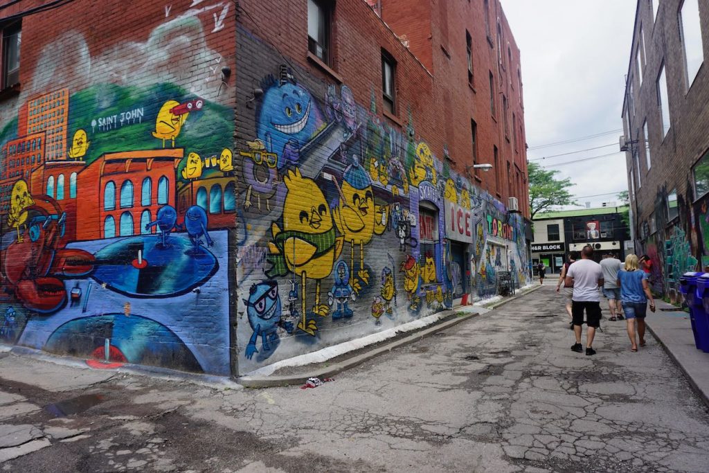 Tourists walking around graffiti alley