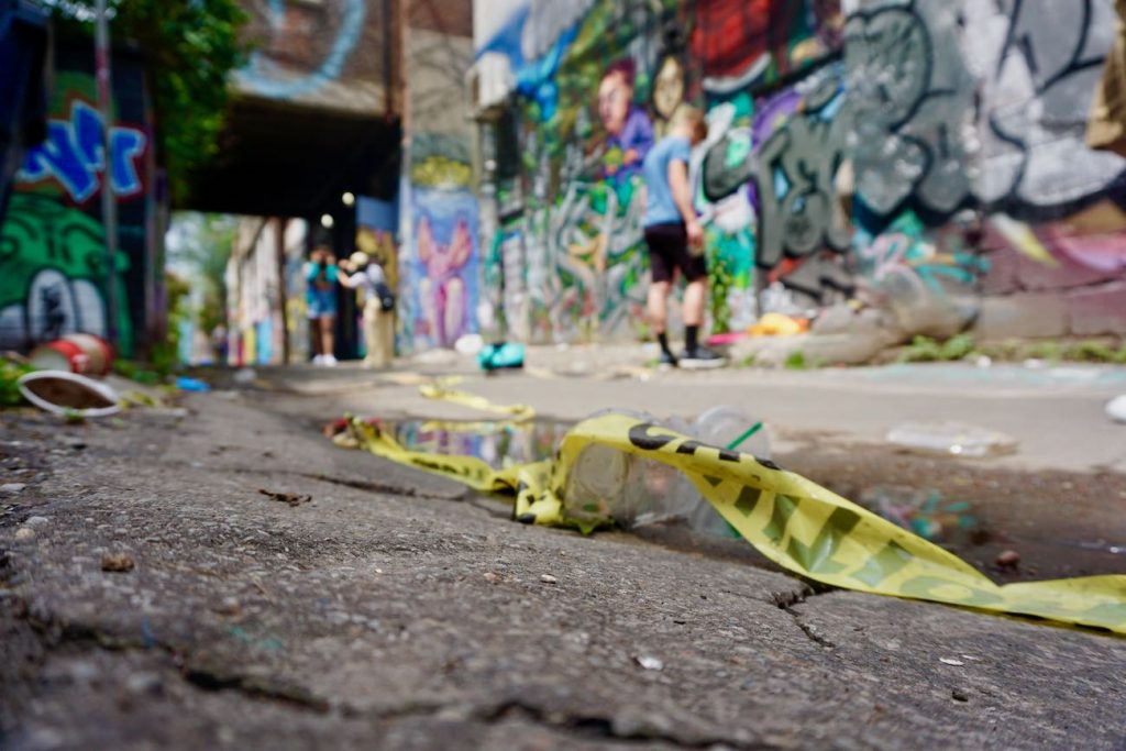 a close up of rubble on the floor in graffiti alley