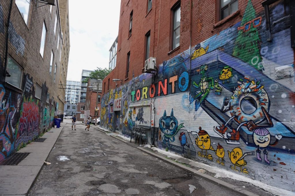 a view down graffiti alley with a Toronto themed mural